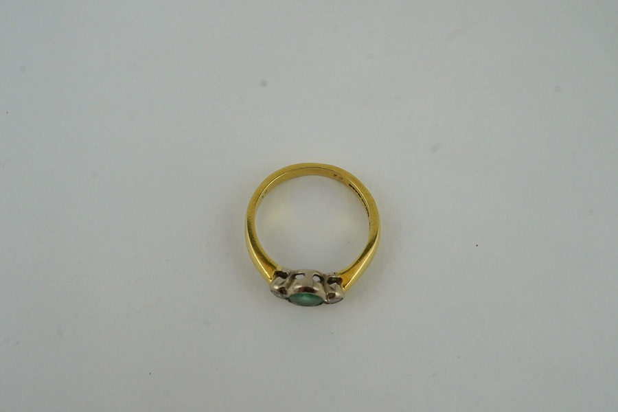 A modern 18ct gold, emerald and diamond set three stone ring, size N, gross weight 4.4 grams. Condition - fair